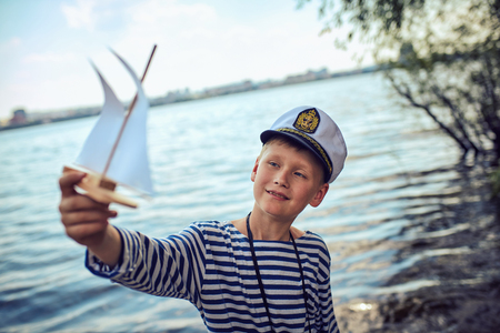 A young boy dreams of becoming a sailorの写真素材