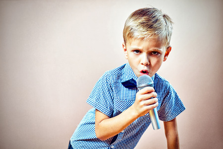 A child with a microphone in his handの写真素材