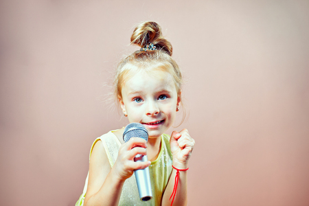 A child with a microphone in his handの写真素材