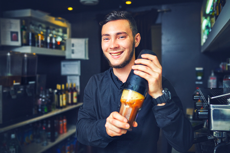 Barman at work, preparing cocktails. concept about service and beverages.の写真素材