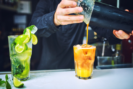 Barman at work, preparing cocktails. concept about service and beverages.の写真素材