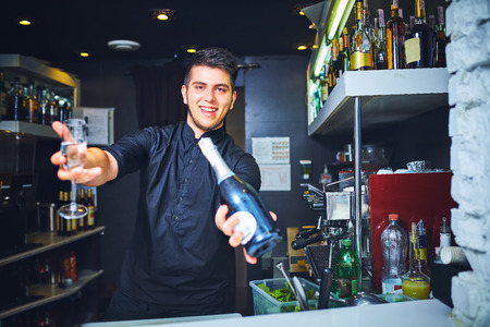 Bartender with empty champagne glass in barの写真素材