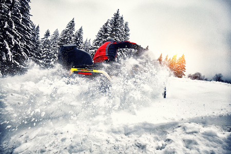 Rider driving in the quadbike race in winter in the forestの写真素材