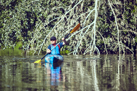 Man paddling in a kayak on  river.の写真素材