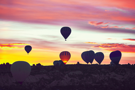 Balloons in the sky above the rocks.の写真素材