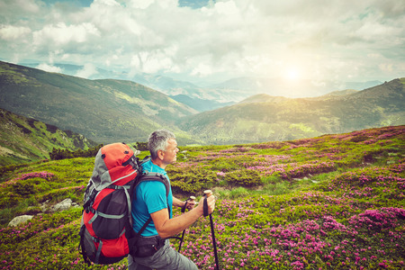 Man with backpack hiking in mountains Travel Lifestyle success concept adventure active vacations...