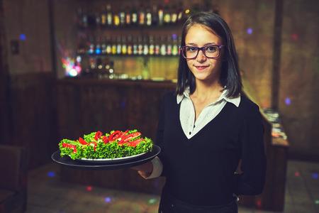 Waiters distribute plates with dishes at the celebrationの写真素材