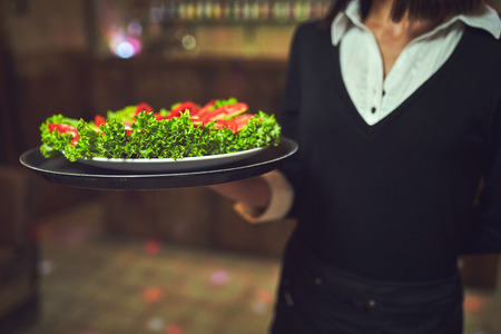 Waiters distribute plates with dishes at the celebrationの写真素材