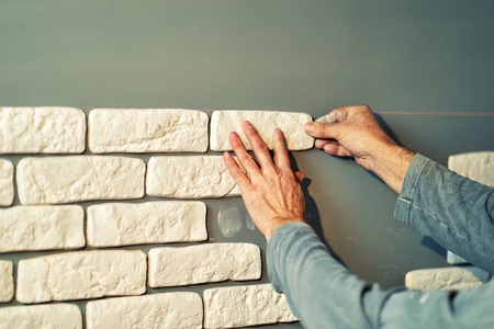 Worker lays decorative tiles in the apartmentの写真素材