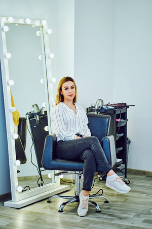 Professional hairdresser working with client in salonの写真素材