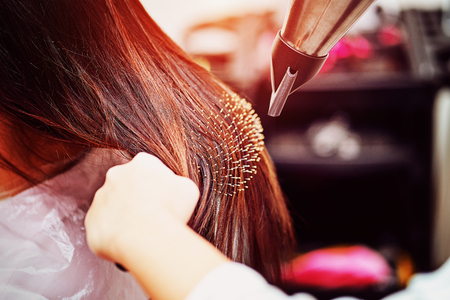 Close-up of hair dryer for hair drying, concept hair salon, female stylist.の写真素材