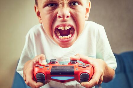 Young kids play video games on their ownの写真素材