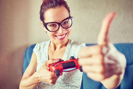 Young woman emotionally making faces playing video games