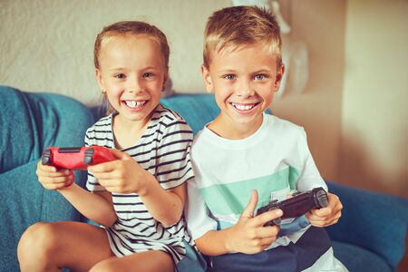 Young kids play video games on their own