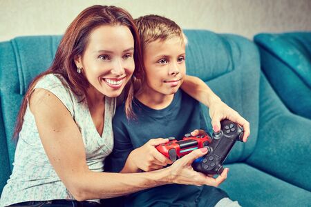 Young woman and child emotionally playing video games