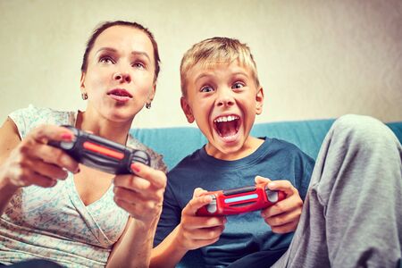 Young woman and child emotionally playing video games