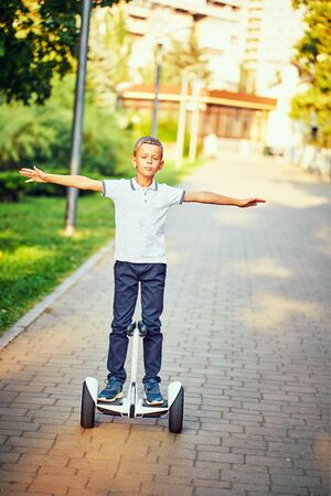 Child on hover board. Kids riding scooter