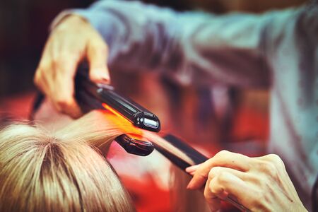 Woman at the hair salon getting her hair styledの写真素材