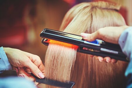 Woman at the hair salon getting her hair styledの写真素材