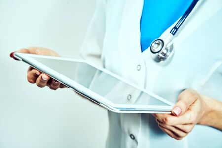 Woman doctor using tablet computer in hospital