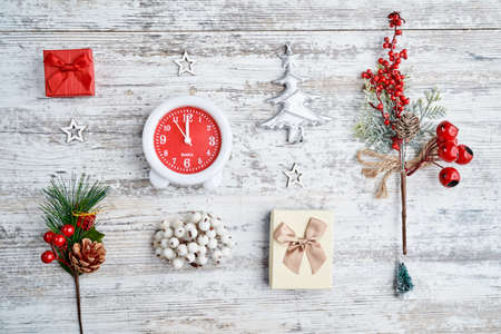 clock on background on a wooden table decorated with a garland and red Christmas balls for the New Year or XMAS. Copy spaceの写真素材