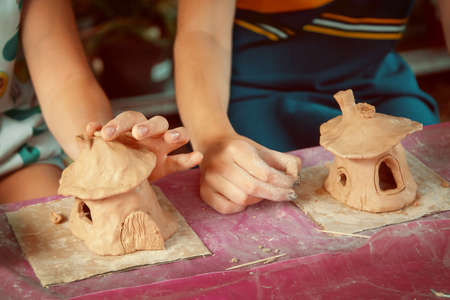 Children playing together with modeling clay and drawing by paints.の写真素材
