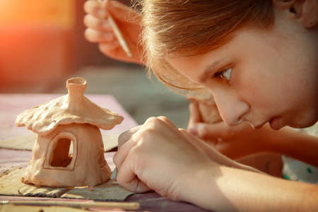 Children playing together with modeling clay and drawing by paints.の写真素材