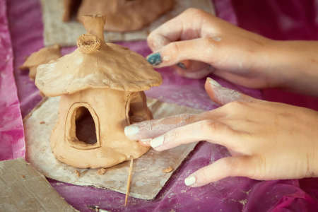 Children playing together with modeling clay and drawing by paints.の写真素材
