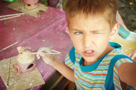 Children playing together with modeling clay and drawing by paints.の写真素材