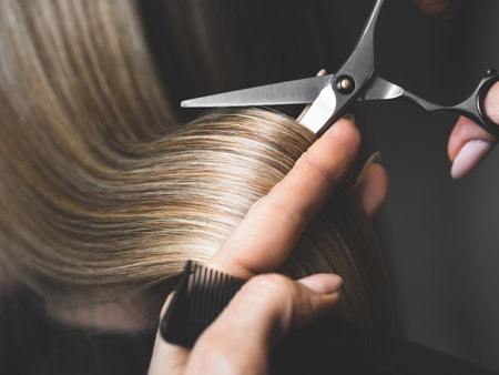 Hairdresser doing haircut. Professional hairdresser scissorsの写真素材