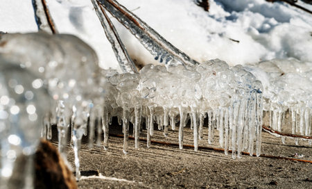 Icicle, dirty ice stalactite sharpened downward when melting dirty snowの写真素材