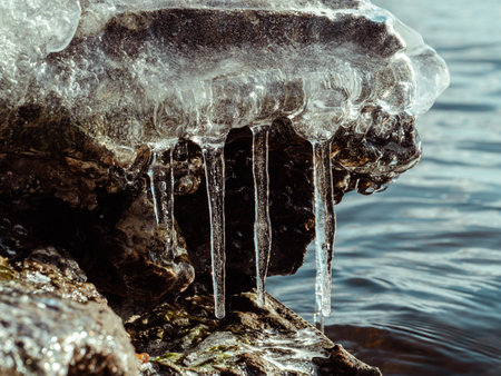 Icicle, dirty ice stalactite sharpened downward when melting dirty snow