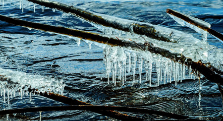 Icicle, dirty ice stalactite sharpened downward when melting dirty snowの写真素材