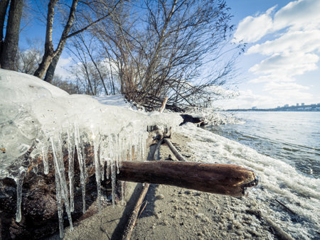 Icicle, dirty ice stalactite sharpened downward when melting dirty snowの写真素材
