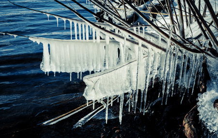 Icicle, dirty ice stalactite sharpened downward when melting dirty snowの写真素材