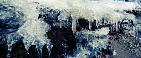 Icicle, ice stalactite sharpened downward when melting snowの写真素材