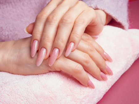 Beautiful Woman Hands. Spa and Manicure concept. Female hands with pink manicure.の写真素材
