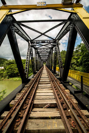 The railways have many viaducts and tunnels because of the longitudinal slope. Wood and steel, railway bridge over river.の写真素材