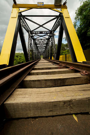 The railways have many viaducts and tunnels because of the longitudinal slope. Wood and steel, railway bridge over river.の写真素材