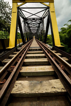The railways have many viaducts and tunnels because of the longitudinal slope. Wood and steel, railway bridge over river.の写真素材