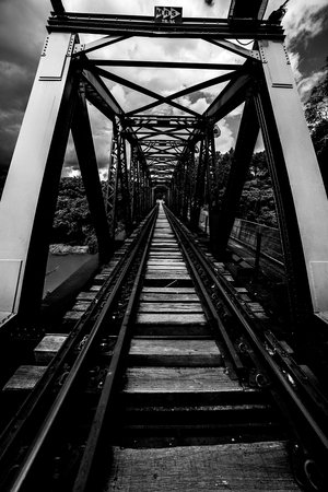 The railways have many viaducts and tunnels because of the longitudinal slope. Wood and steel, railway bridge over river.の写真素材
