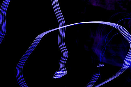 Light painting, light painting, light drawing, or light art performance photography are terms that describe photographic techniques of moving a light source while taking a long exposure photograph, either to illuminate a subject or space, or to illuminate the camera to 'draw', or moving the camera itself while exposing light sources.の写真素材