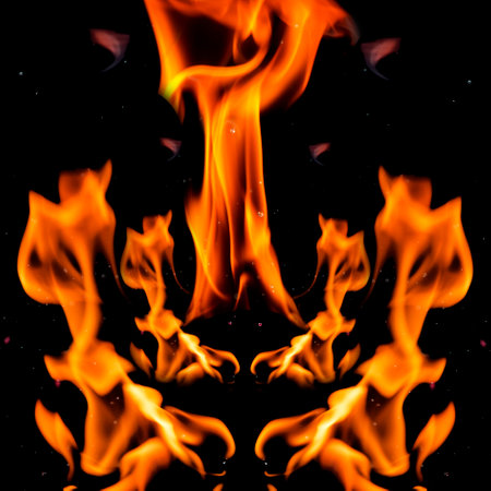 Water mixed with lighter fluid inside a golden pot throwing ice stone to cause thermal shock and cause a splash of liquid with fire on the black background.の写真素材