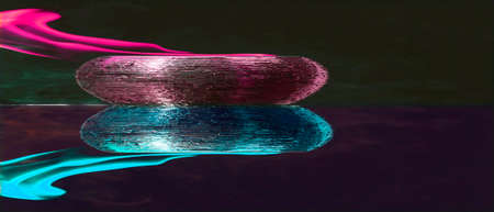Water mixed with lighter fluid inside a golden pot throwing ice stone to cause thermal shock and cause a splash of liquid with fire on the black background.の写真素材