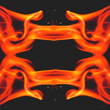 Water mixed with lighter fluid inside a golden pot throwing ice stone to cause thermal shock and cause a splash of liquid with fire on the black background.の写真素材