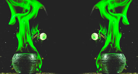 Water mixed with lighter fluid inside a golden pot throwing ice stone to cause thermal shock and cause a splash of liquid with fire on the black background.の写真素材