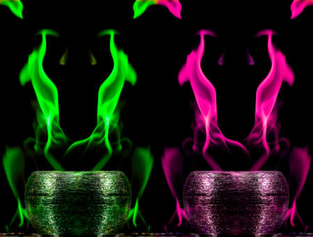 Water mixed with lighter fluid inside a golden pot throwing ice stone to cause thermal shock and cause a splash of liquid with fire on the black background.の写真素材
