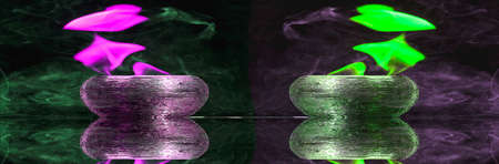 Water mixed with lighter fluid inside a golden pot throwing ice stone to cause thermal shock and cause a splash of liquid with fire on the black background.の写真素材
