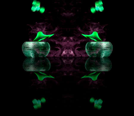 Water mixed with lighter fluid inside a golden pot throwing ice stone to cause thermal shock and cause a splash of liquid with fire on the black background.の写真素材