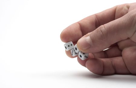 Dices in hand over white backgroundの写真素材